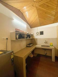 a kitchen with a wooden desk and a sink at Uptown Boutique Homes - Room 1 in Shimla