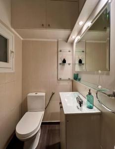 a bathroom with a toilet and a sink at Spacious 2BDs Apt With Acropolis View In Center in Athens