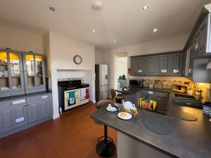 a large kitchen with a counter top in a room at Cliff haven in Borth +29 photos