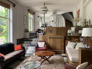 a living room with couches and a table at Petite Source in Varengeville-sur-Mer