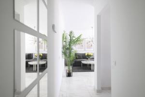 a living room with a couch and tables with flowers at Sun Club Playa del Ingles in Playa del Ingles
