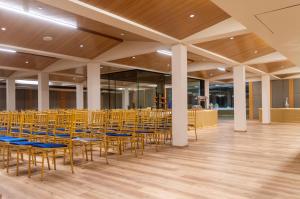 a room with chairs and tables in a building at Pathikashram Nilaya in Gandhinagar