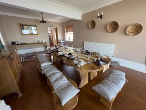 a room with a wooden table with pillows on it at Cliff haven in Borth