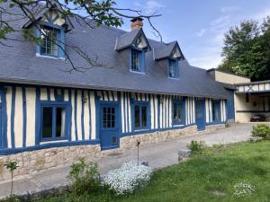 a blue and white house with a blue door at Maison de Suzon in Saint-Pierre-le-Viger