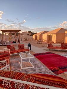 a group of tents in the middle of the desert at Pulse Desert Camp in Merzouga