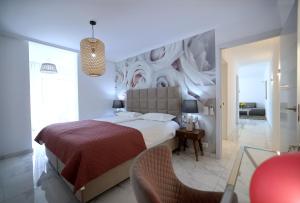 a bedroom with a large bed with a painting on the wall at Sun Club Playa del Ingles in Playa del Ingles +159 photos