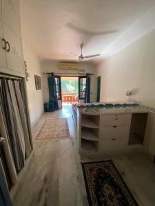 an empty living room with a ceiling fan and a room at Neela House in Kovalam