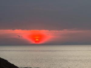 a sun setting over the ocean with birds flying at Mama's Bungalows Koh Chang Ranong in Koh Chang Ranong