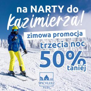 a person is skiing down a snow covered slope at Spichlerz na Krakowskiej in Kazimierz Dolny