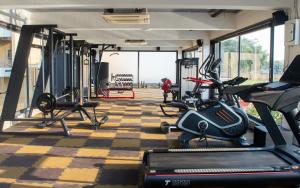 a gym with treadmills and elliptical machines at Pathikashram Nilaya in Gandhinagar