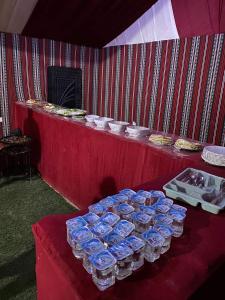 a table with a bunch of plates of food on it at wadi rum caeser camp in Wadi Rum