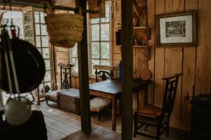 a room with a table and chairs in a house at Les cabanes de roquehort in Salies-de-Béarn