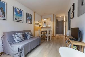 a living room with a couch and a table at Les Marmottes En Chaussettes - Happy Rentals in Chamonix-Mont-Blanc