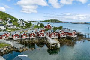 an aerial view of a village with red houses on the water at Reine Rorbu, Amaliebua in Reine