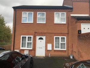 a red brick house with a white door at 1 bed fully furnished Walsall property in Walsall
