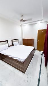 a bedroom with a large bed in a room at Govind puri residency in New Delhi