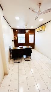 a living room with a table and a tiled floor at Govind puri residency in New Delhi