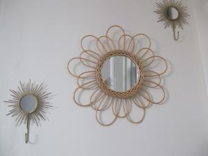 a metal mirror and two mirrors on a wall at Studio avec cour extérieure aux portes de Paris in Bagnolet