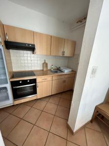 a kitchen with wooden cabinets and a sink and a stove at Villa Julian & Juliana in Krk