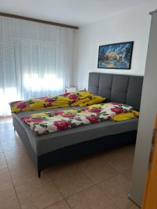 a bedroom with a bed with a floral comforter at Villa Julian & Juliana in Krk