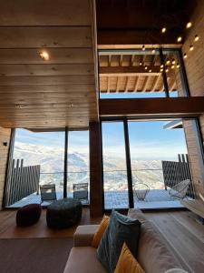a living room with a couch and views of the mountains at Lux 12 in Sierra Nevada