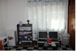 a toy kitchen with two chairs and a refrigerator at Kind private room 8 in Addis Ababa