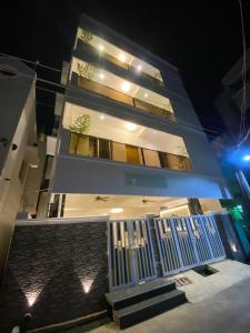 a white building with a staircase in front of it at night at Le Poshe Luxury Pondicherry in Puducherry