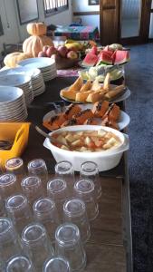 a table topped with plates and bowls of food at Roma Hotel in Porto Alegre +20 photos