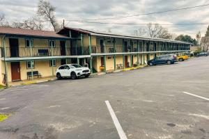 a parking lot with cars parked in front of a motel at Quality Inn & Suites in Jackson