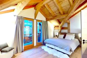 a bedroom with a bed and a large window at CASA-Le Cherk Chalet 300m2 jacuzzi sauna Vars les Claux in Vars