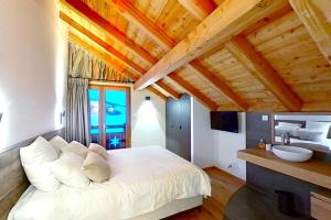 a bedroom with a white bed and a sink at CASA-Le Cherk Chalet 300m2 jacuzzi sauna Vars les Claux in Vars