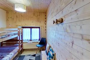 a bedroom with two bunk beds and a chair at CASA-La Fuste center St-Véran foot of the slopes 6p in Saint-Véran