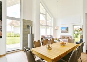 a dining room with a wooden table and chairs at Villa Meereszeit in Trent