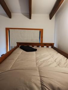 a large bed in a room with a window at Loft Bella Vita in Pucón