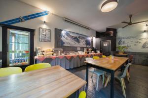 a restaurant with wooden tables and yellow chairs at Hotel Gromada Zakopane in Zakopane +22 photos