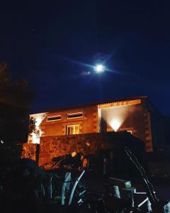 a house at night with a moon in the sky at Waka Waka Pico Azores in Cais do Pico