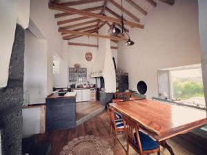 uma cozinha com uma mesa de madeira e uma sala de jantar em Waka Waka Pico Azores em Cais do Pico