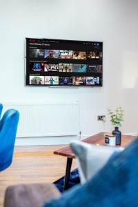 a living room with a tv hanging on a wall at Bv Living Modern 2-Bedroom Apartment in the Heart of Barnsley in Barnsley