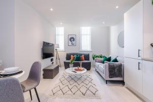 a living room with a couch and a table at Modern Flat in Leeds by PureStay Short Stays in Leeds