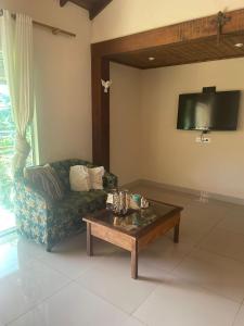 a living room with a couch and a coffee table at Chalés em Ilhabela in Ilhabela