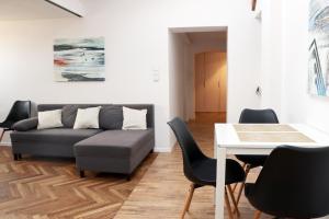 a living room with a couch and a table and chairs at Apartament w sercu Krakowa in Kraków