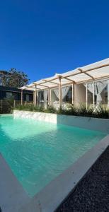 a large pool of water in front of a building at Malujoseignacio in José Ignacio