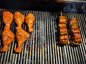 a grill with various types of food on it at The Brown and Brew Homestay in Chikmagalūr