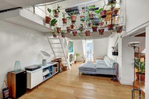 a living room filled with lots of potted plants at Pretty Parisian Penthouse in Paris