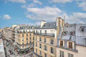 a group of buildings on a city street at Pretty Parisian Penthouse in Paris