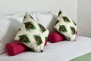 two pillows on a bed with pink pillows at Cathedral Views Period Townhouse w/ Free Parking in Salisbury