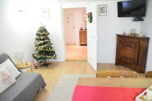un soggiorno con un albero di Natale e un divano di La Petite Maison de la Petite Vallée a Rott Altre 23 foto