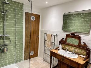 a bathroom with a sink and a shower at Cathedral Views Period Townhouse w/ Free Parking in Salisbury +29 photos