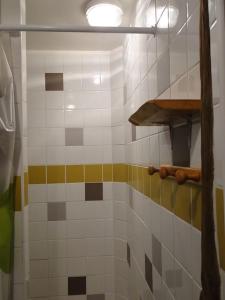 a bathroom with a shower with colorful tiles at Auberge de Lascours, gîte d'étape pleine nature. in Ceilhes-et-Rocozels +39 photos