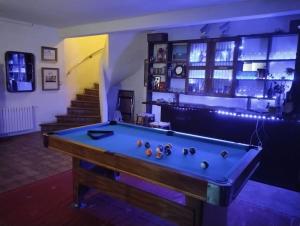 a pool table in a room with a staircase at Villa Alella in Alella
